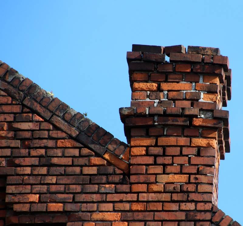 Damaged chimney on an Plympton home showing cracks and missing mortar